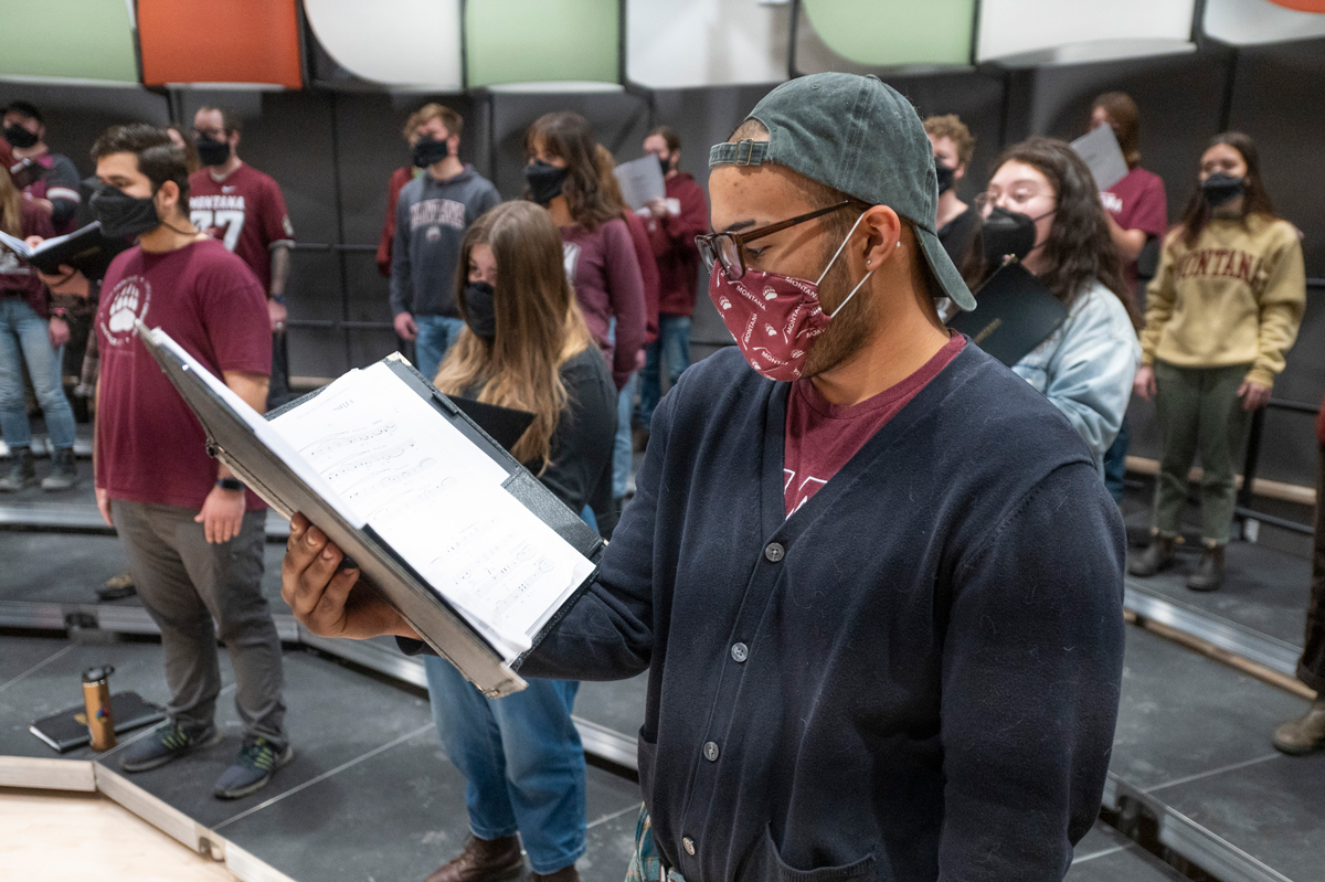 A man sings with a mask on 