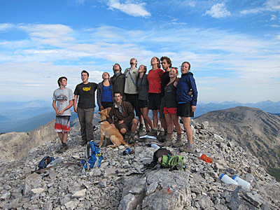 Students howl at the sky together on a mountain summit