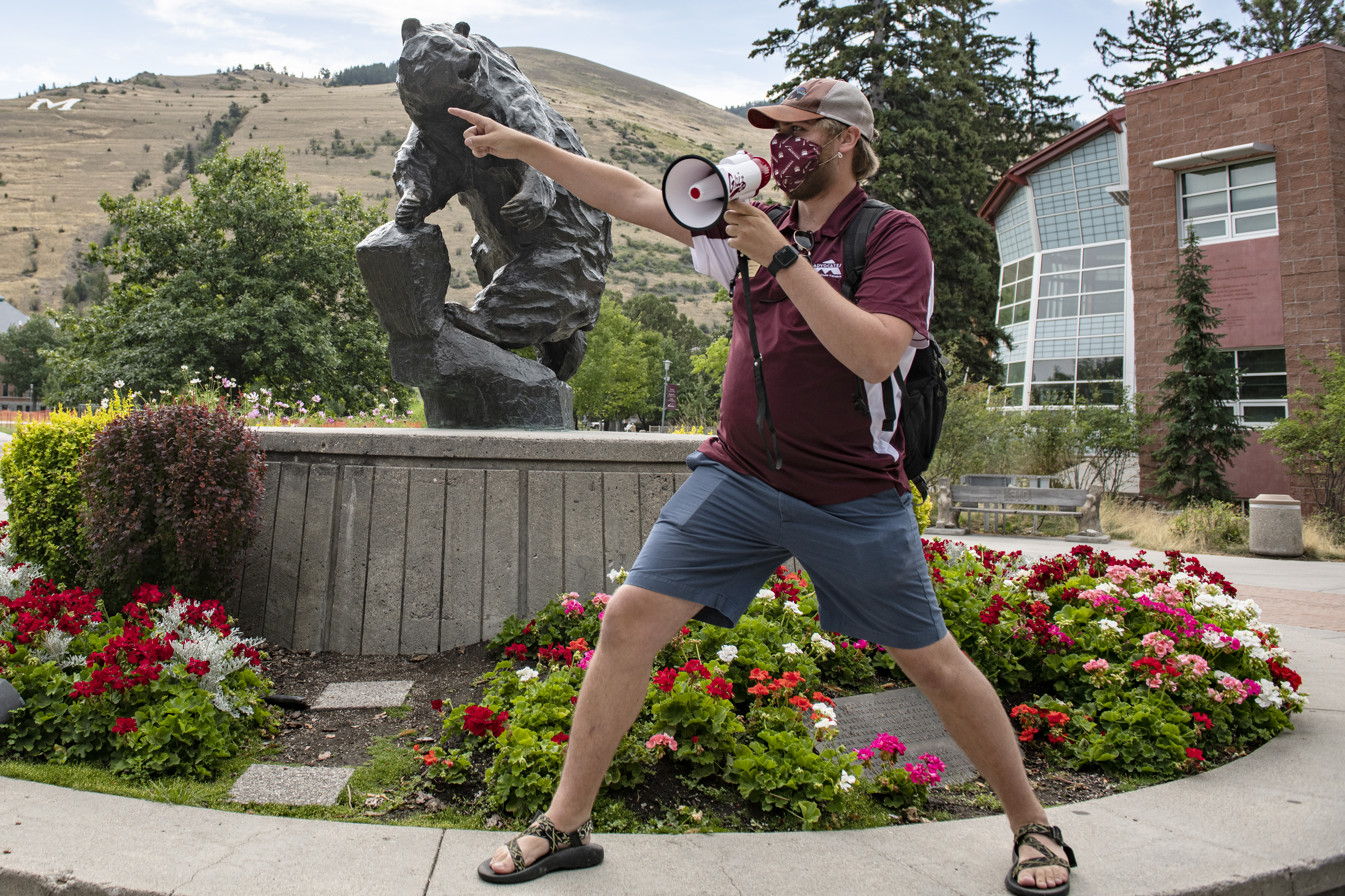 UM Advocate standing at the Grizzly Bear pointing and talking into a megaphone