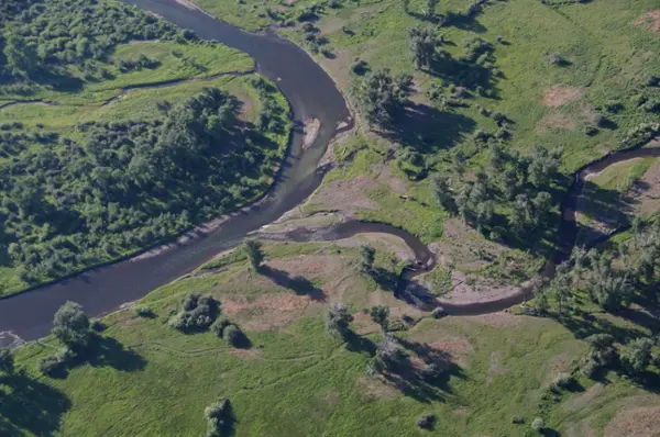 arial view of the flint creek flowing into a curve of the clark fork river