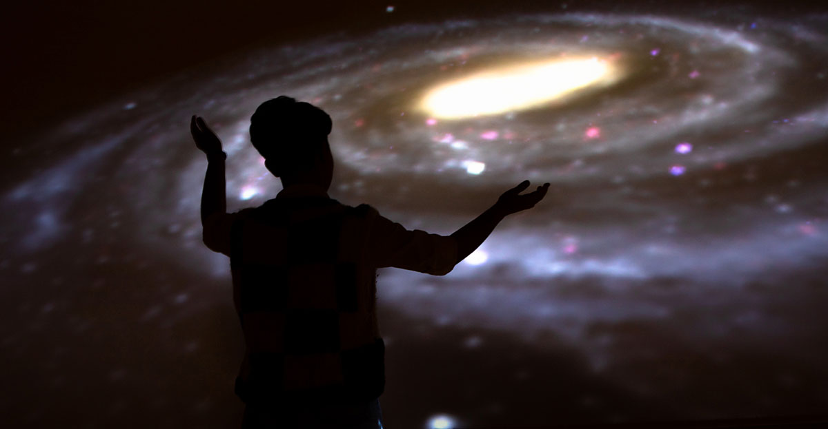student in planetarium