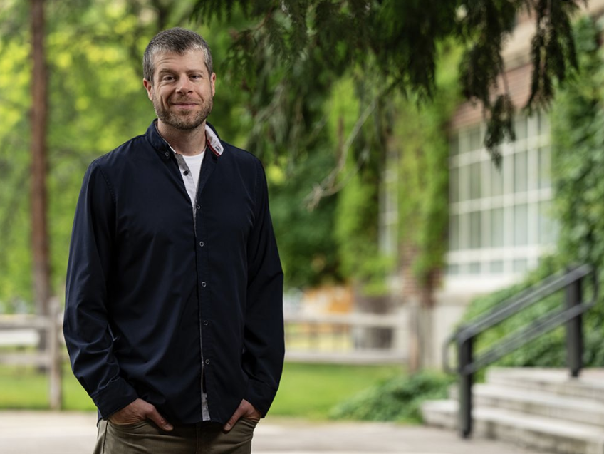 Professor Ethan Walker at the University of Montana standing outside of Skaggs Building.