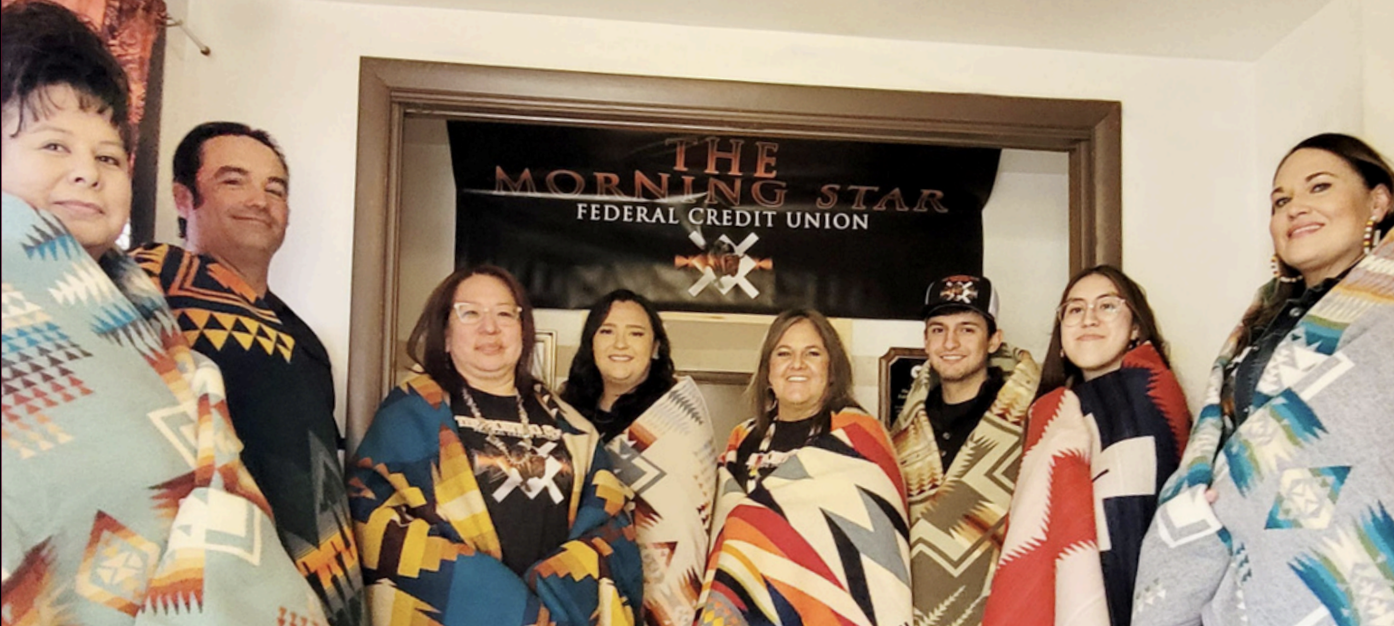 A group of native people wearing blankets