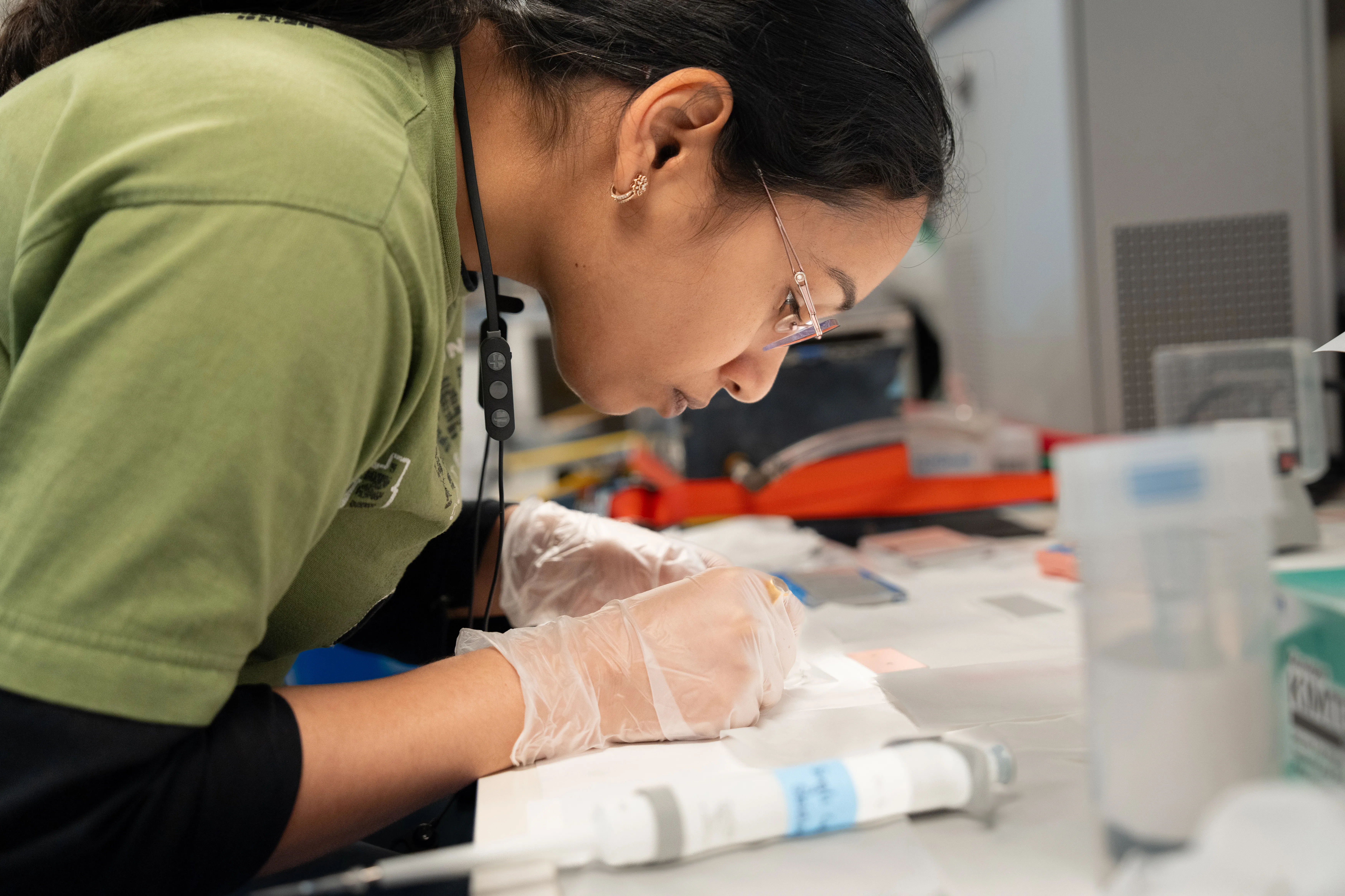 Deepika Sahoo (Scientist, Marine Biogeochemistry and Microbial Ecology at Flathead Lake Biological Station, University of Montana) processes tiny samples of seawater to see what chemical nutrients (such as carbon, nitrogen, and phosphorus) are inside individual microbes, an experiment carried out in the main lab aboard Falkor (too). CREDIT: Bernarda Cornejo Pinto / Schmidt Ocean Institute