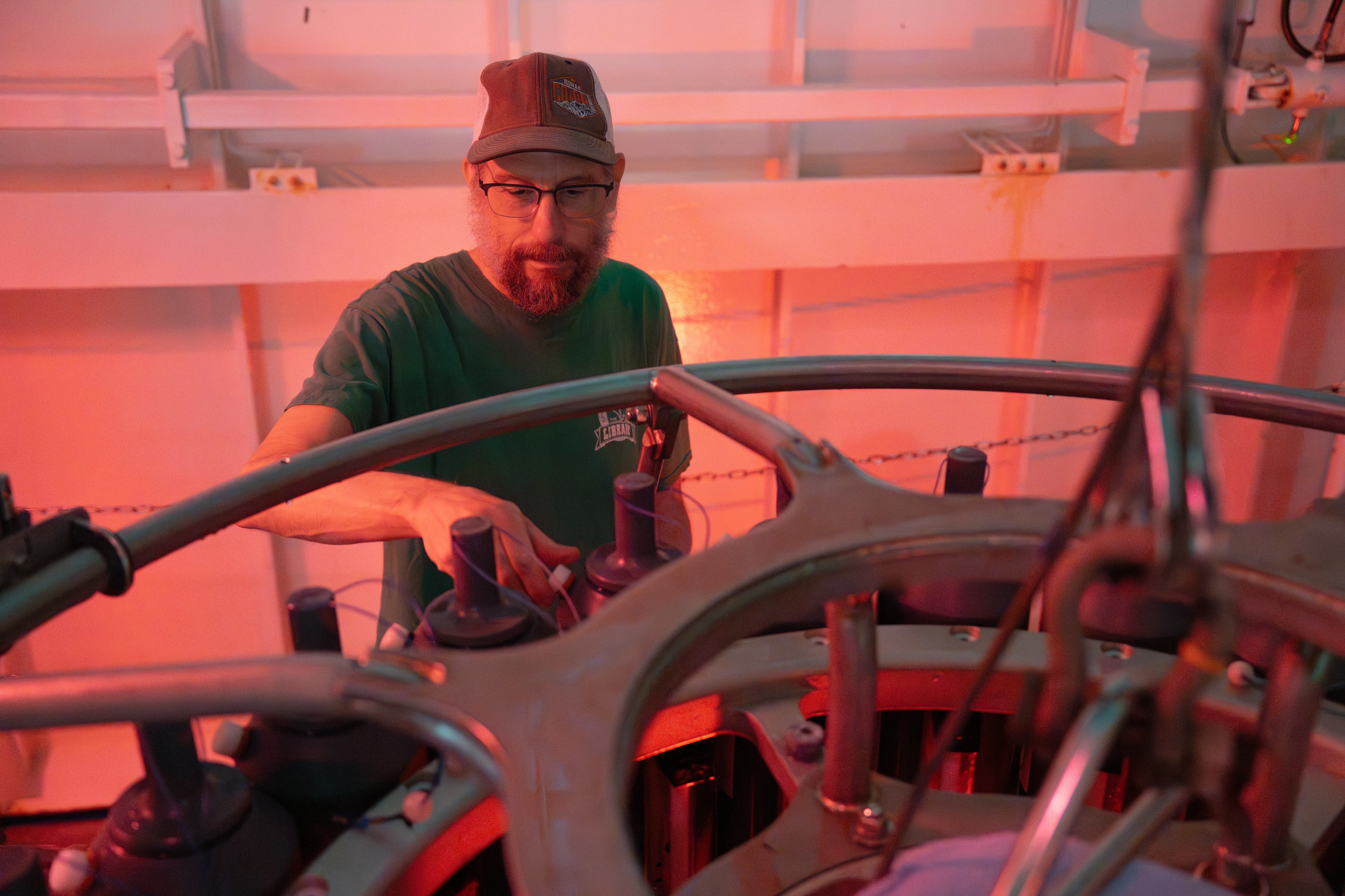 Robert Hall, Professor of Limnology at Flathead Lake Biological Station, University of Montana opens Niskin Bottle from the CTD Rosette to collect seawater samples for productivity estimates aboard Falkor (too) to link to process models of carbon cycling. CREDIT: Bernarda Cornejo Pinto / Schmidt Ocean Institute