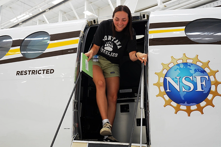 Student stepping out of NSF research aircraft