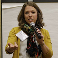 woman speaking into hand-held microphone