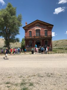 historic brick building. group of people in front. 