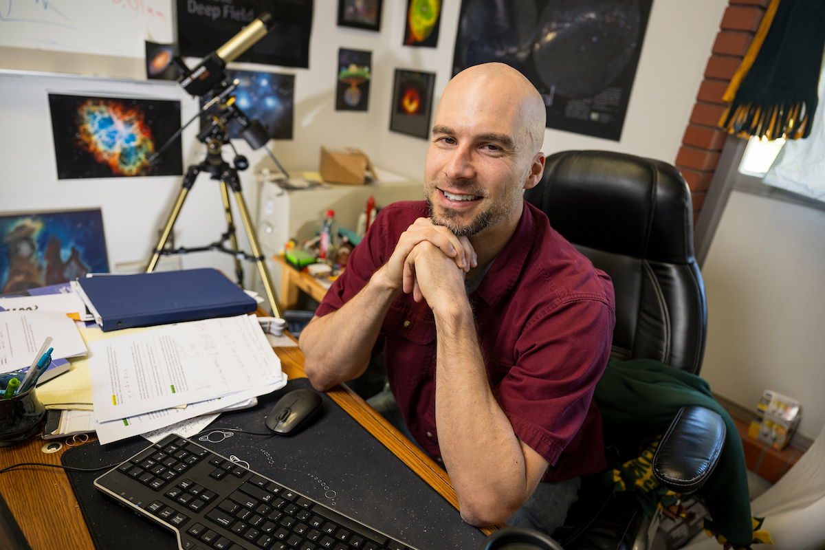 Mark smiles at camera in his office.