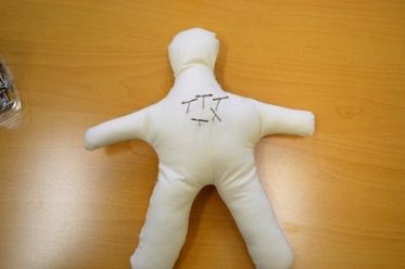 image of voodoo doll with pins