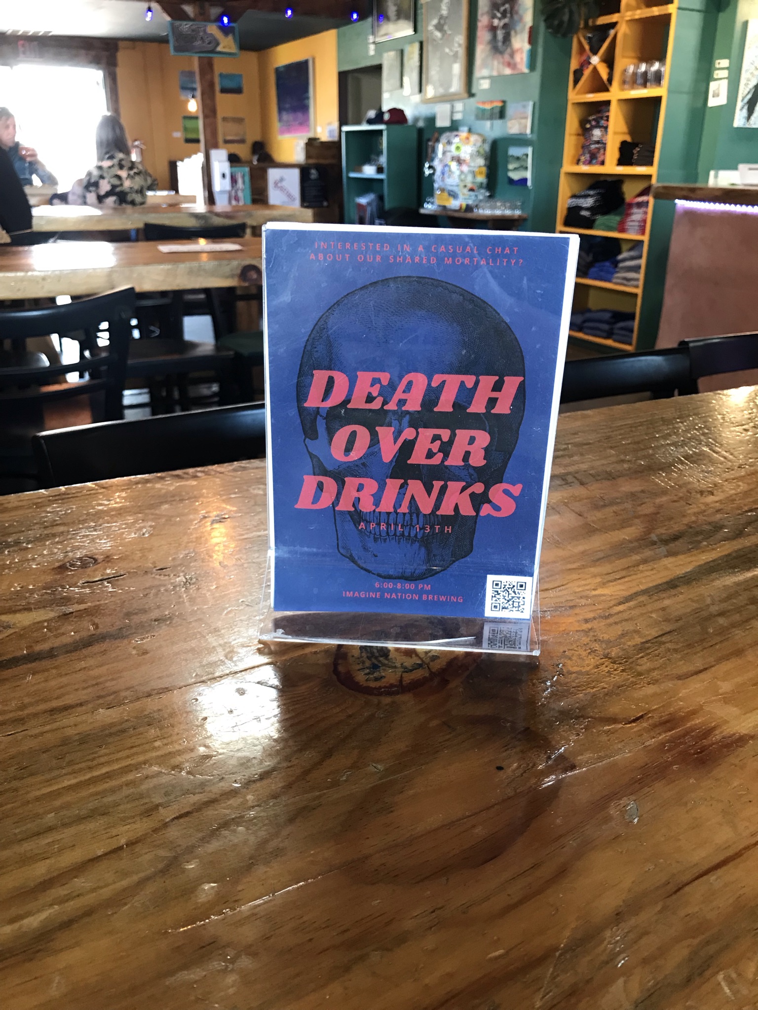 death over drinks standup display on table of bar