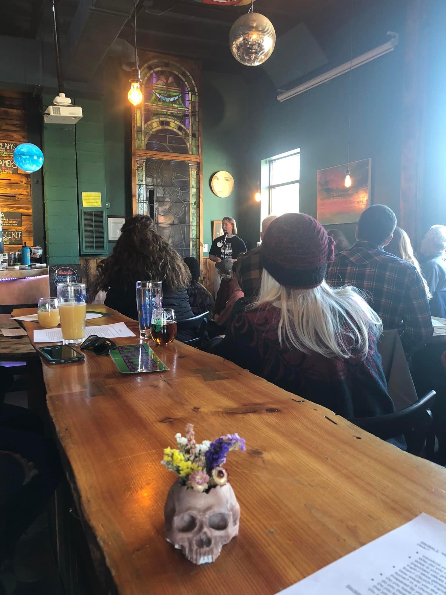 view of people listening to speaker at front of room