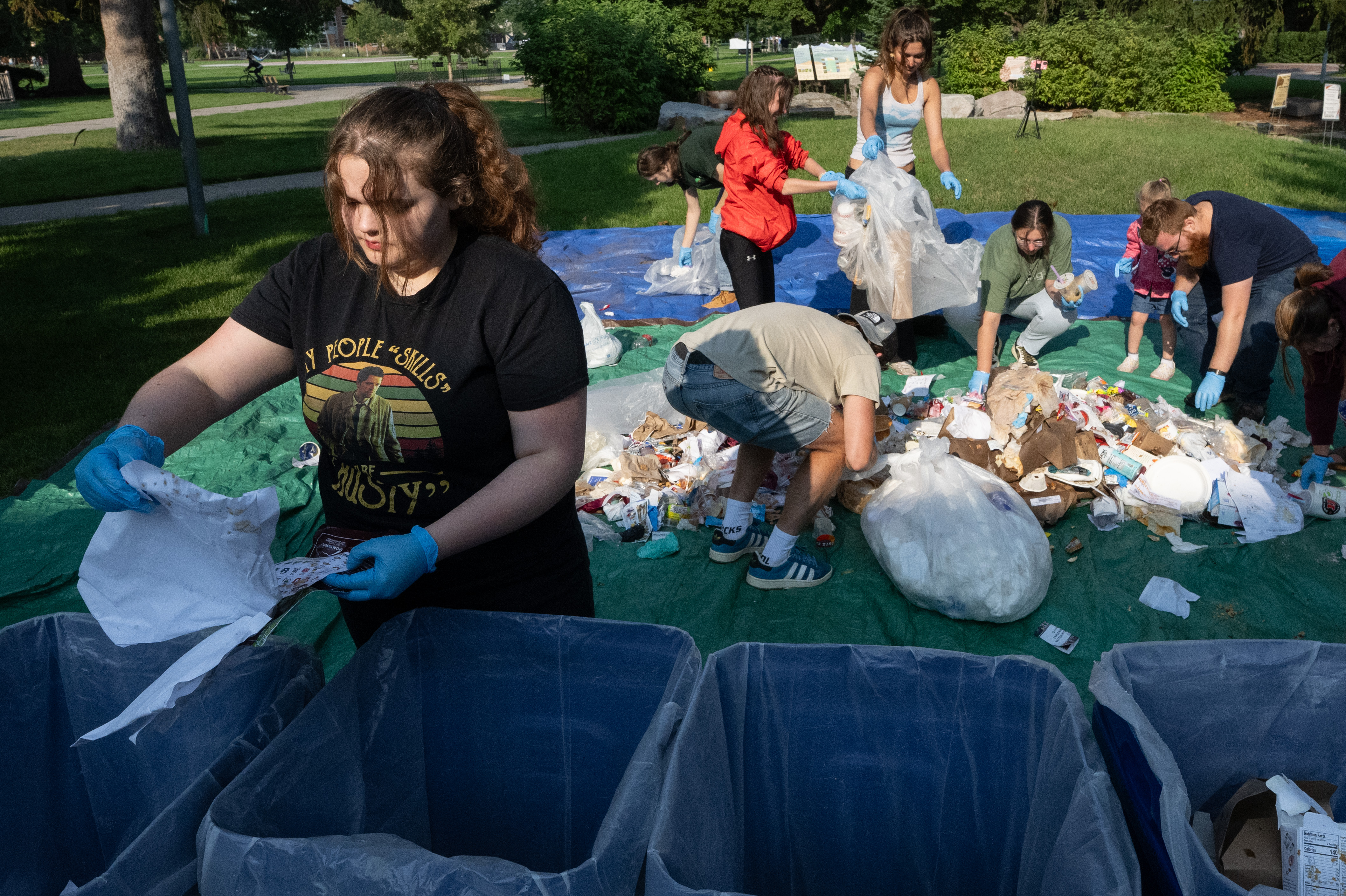 students stand on tarps in the oval and sort waste for their Big Sky Experience