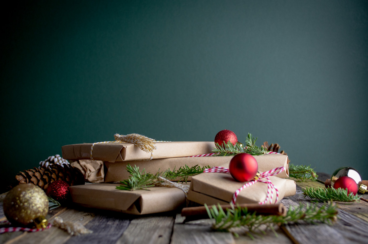 presents wrapped in brown paper with decorations scattered around