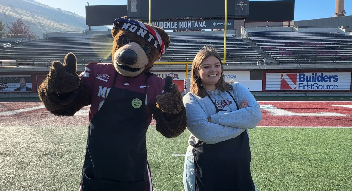 zoe and monte pose back to back for a photo