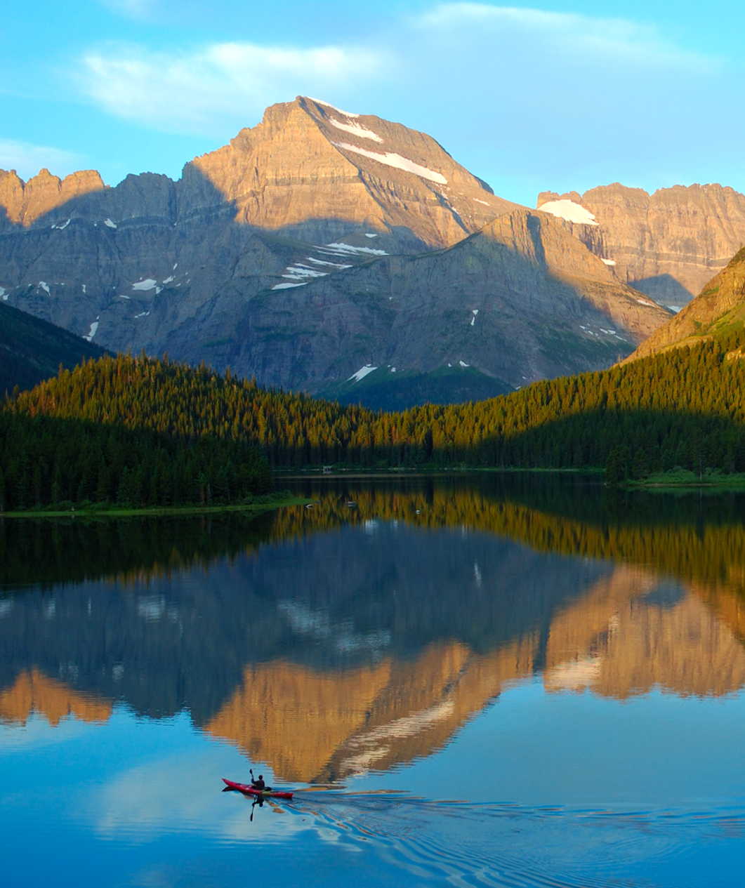 A kayaker enjoys Swiftcurrent Lake in Glacier National Park.