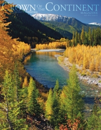 magazine cover featuring a river with fall colored trees and a snowy mountain in the background