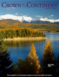 magazine cover featuring a lake amongst a forest with snowy mountains in the background