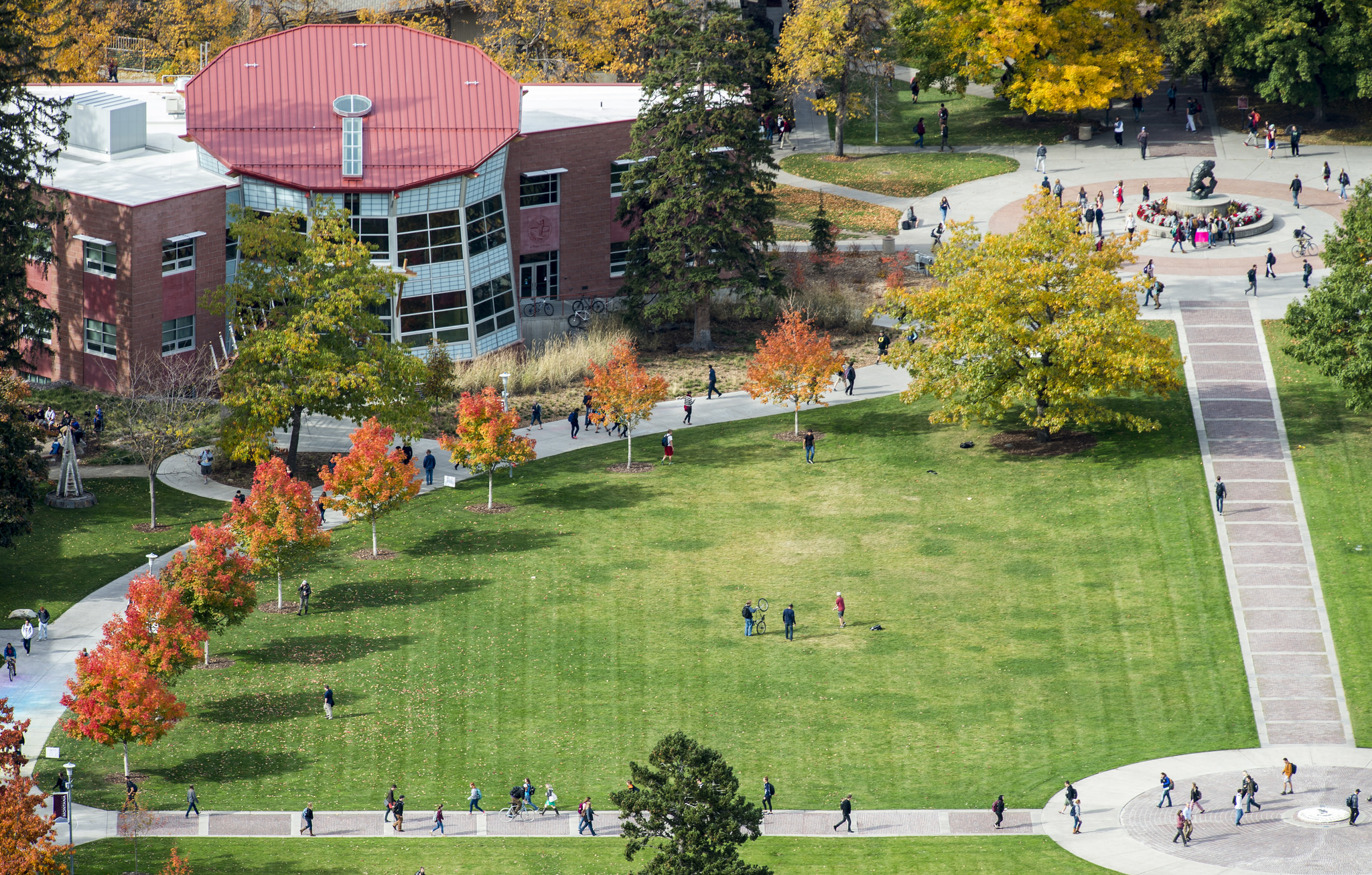Students walking across Oval in Autumn