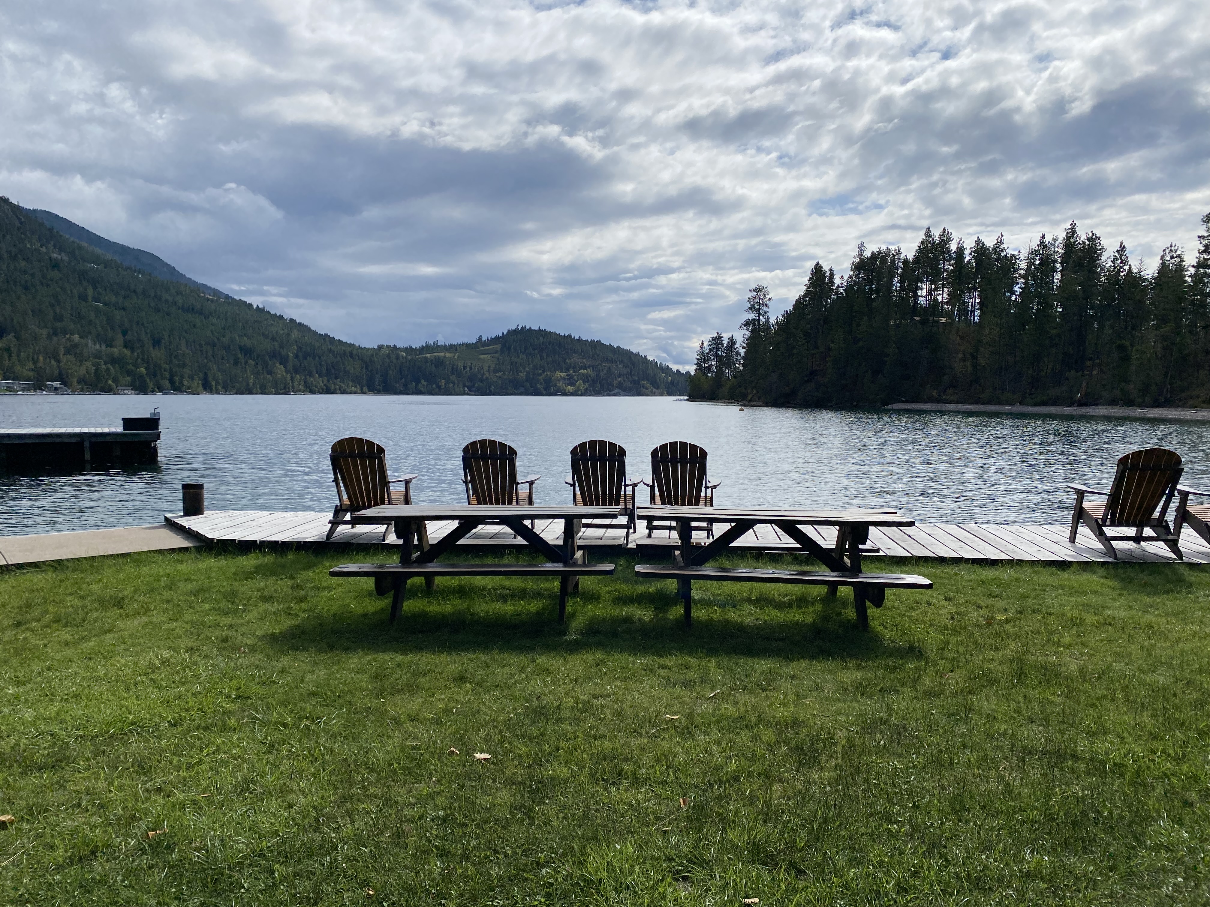 Deck chairs line a dock before Flathead Lake